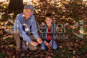 Grandfather and grandson at park during autumn
