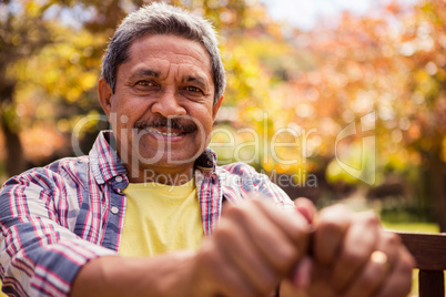 Portrait of elderly man sitting on the bench