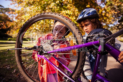 Concentrated siblings repairing mountain bike