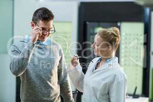 Female optometrist prescribing spectacles to patient