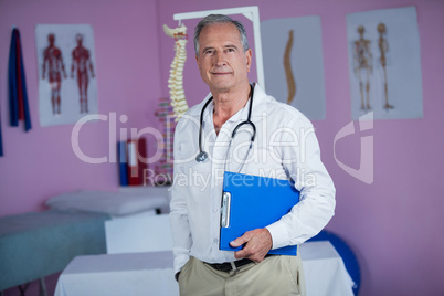 Portrait of physiotherapist holding clipboard