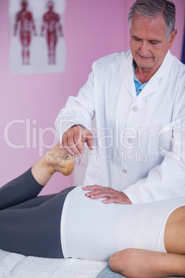 Physiotherapist giving leg massage to a woman