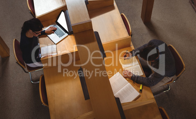 Mature student studying in library