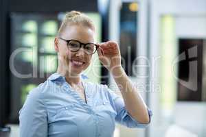Smiling female customer trying spectacle