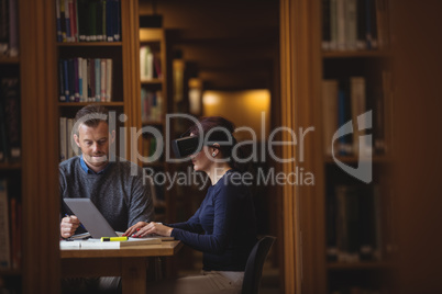 Mature students working together in college library