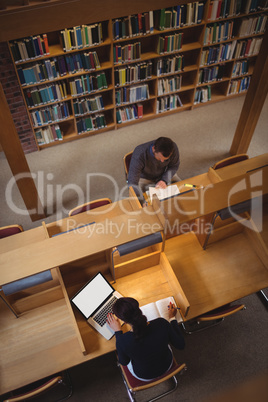 Mature student studying in library