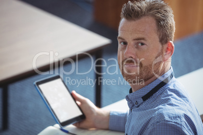 Mature student holding digital tablet