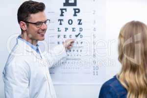 Optometrist taking eye test of female patient