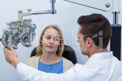 Optometrist interacting with female patient