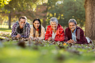 Portrait of family lying at park