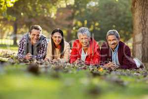 Portrait of family lying at park