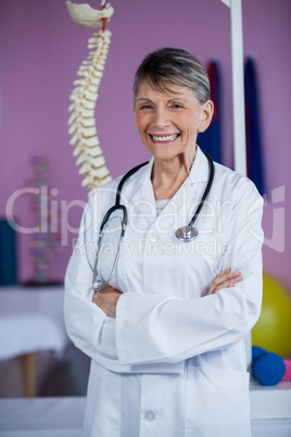 Portrait of physiotherapist standing with arms crossed
