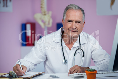 Physiotherapist writing on clipboard