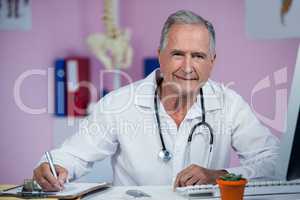 Physiotherapist writing on clipboard