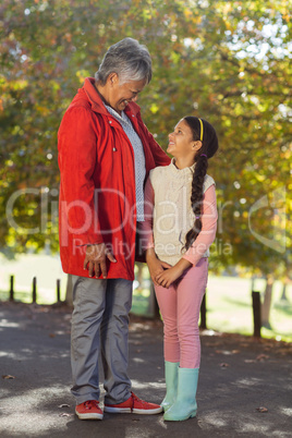 Granddaughter and grandmother looking at each other at park