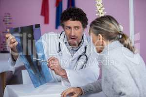 Physiotherapist explaining x-ray to patient