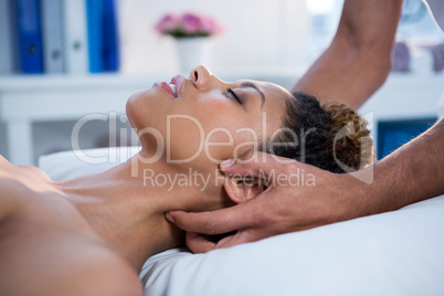 Woman receiving neck massage from physiotherapist