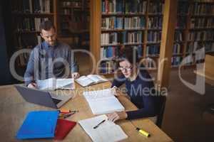 Mature students working together in college library