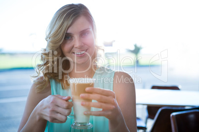 Portrait of smiling woman holding a coffee cup