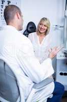 Male optometrist talking to female patient