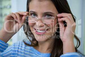 Female customer wearing spectacles in optical store