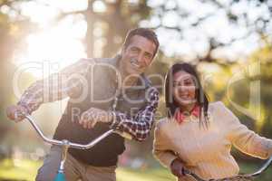 Portrait of smiling couple with bicycles