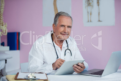 Portrait of physiotherapist using digital tablet