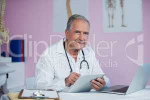 Portrait of physiotherapist using digital tablet