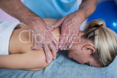 Woman receiving neck massage from physiotherapist