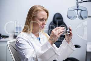 Female optometrist looking through messbrille