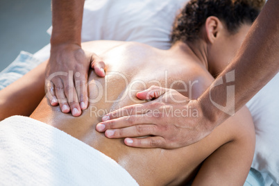 Woman receiving back massage from physiotherapist