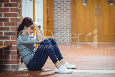 Stressed mature student sitting in locker room