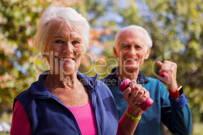 Elderly couple making fitness and lifting hand weight