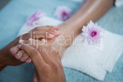Physiotherapist giving foot massage to a woman