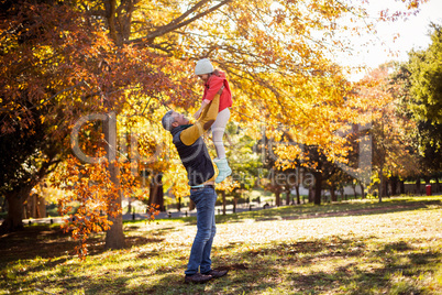 Full length of father holding daughter at park