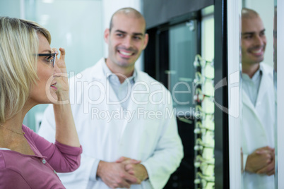 Optometrist consulting a customer about spectacles and frames