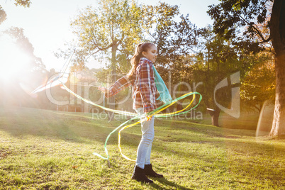 Full length of girl playing with kite