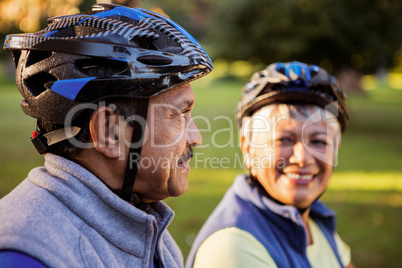 Close up of mature couple holding cycling helmet