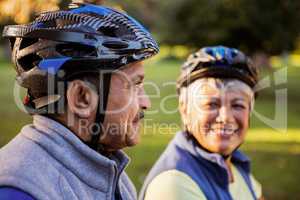 Close up of mature couple holding cycling helmet