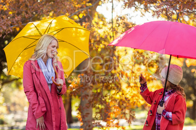 Girl photographing mother at park