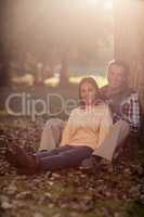 Portrait of smiling couple sitting at park