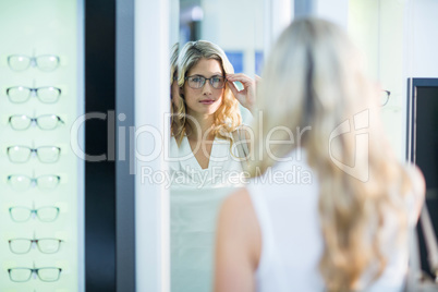 Beautiful female customer trying spectacles