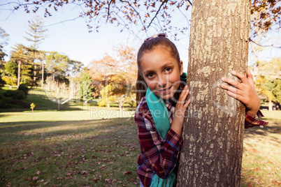 Portrait of happy girl hugging tree
