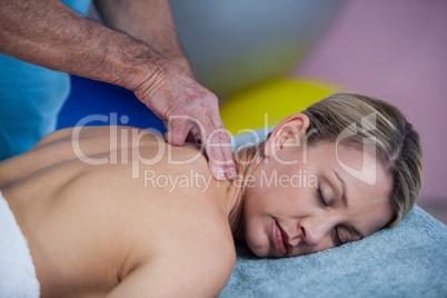 Woman receiving neck massage from physiotherapist