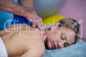 Woman receiving neck massage from physiotherapist