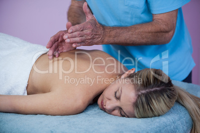 Woman receiving back massage from physiotherapist