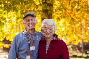Portrait of senior couple standing at park