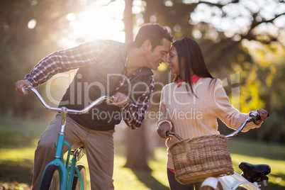 Romantic couple with bicycles at park