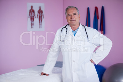 Portrait of physiotherapist standing with hands on hip