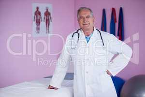 Portrait of physiotherapist standing with hands on hip